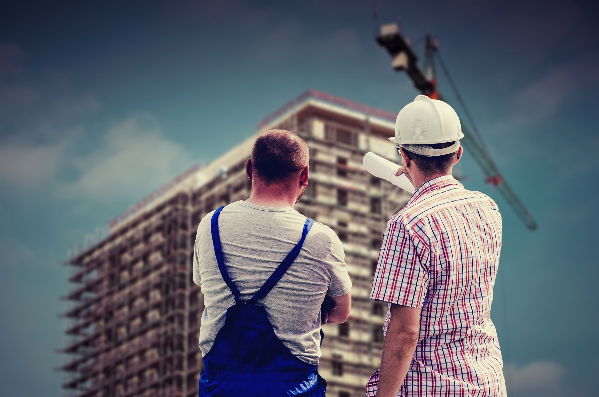 Architect Talking with Employee in Front of Building